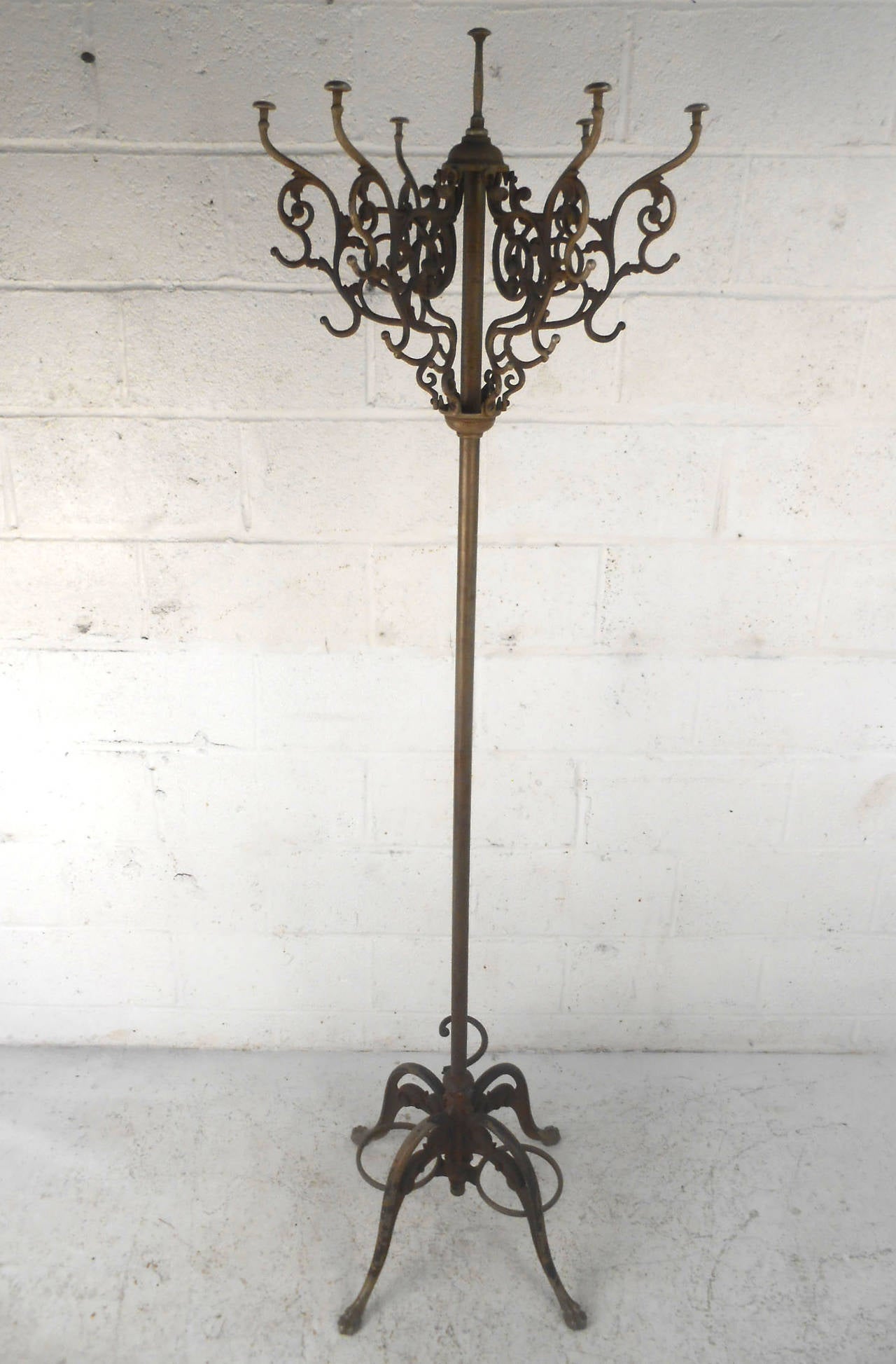 This beautiful and unique cast iron coat rack features a beautiful vintage finish, a nice mix of oxidation and age related wear for an authentic antique feel. Top rack spins, sturdy and heavy piece. Please confirm item location (NY or NJ).