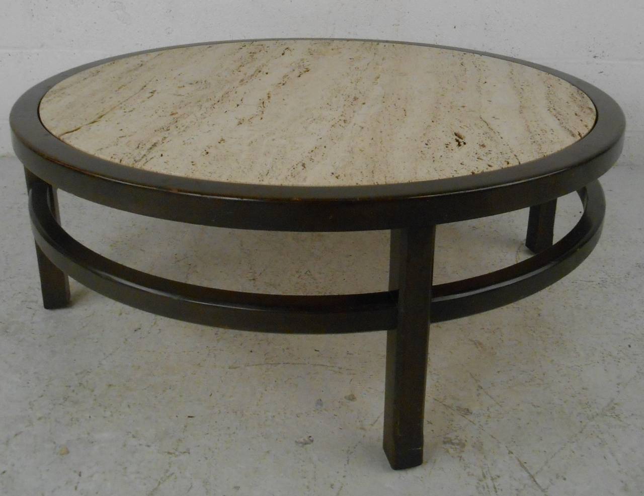 This mid-century modern round black lacquer coffee table with textured travertine top features the exquisite vintage design of John Widdicomb. Please confirm item location (NY or NJ) with dealer.