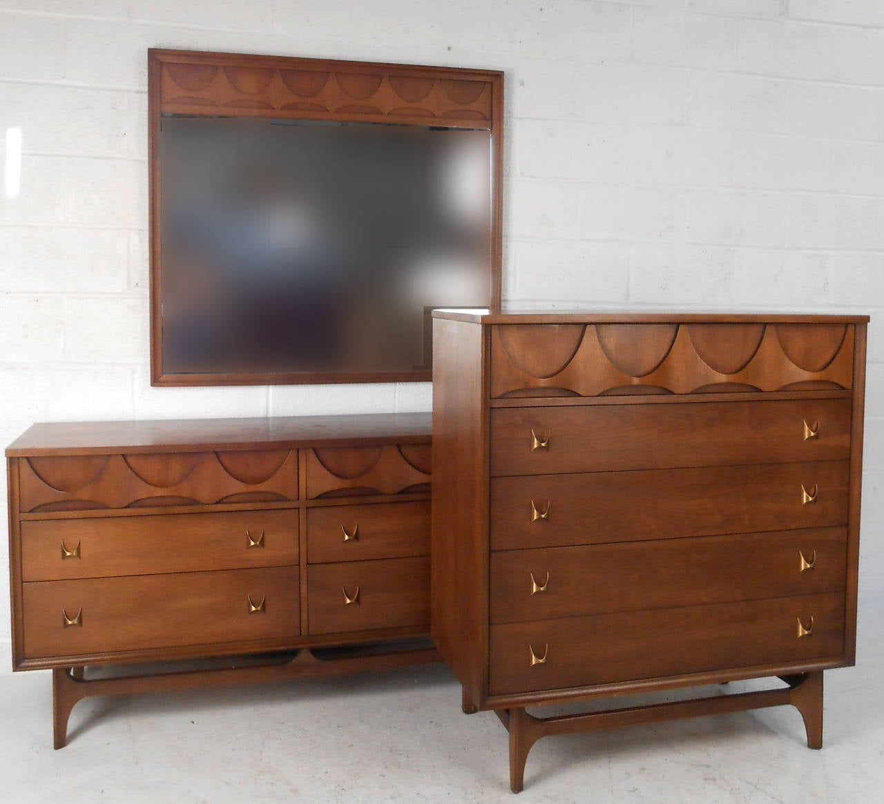 This matching three piece bedroom set showcases the wonderful Brasilia style made so popular by mid-century Broyhill manufacturing. With unique drawer pulls, sculpted drawer fronts, and plenty of drawer space this mid-century bedroom set is the