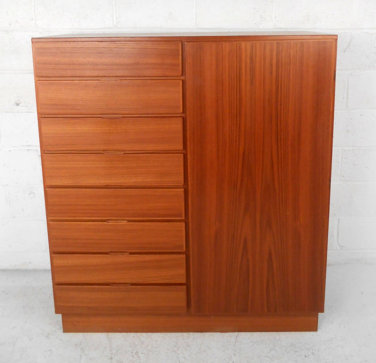 This multi-functional storage cabinet features heavy teak construction, finished back, and plenty of versatile storage for virtually any need.  Beautiful teak finish makes this a wonderful mid-century addition to any room in need of cabinet and