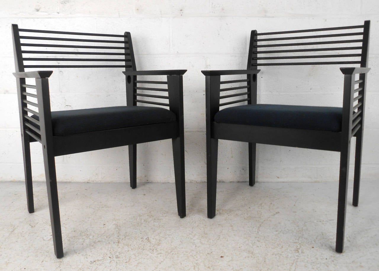 This matching pair of vintage style side chairs feature unique horizontal spoke backs, tapered frames, and upholstered seat. Unique lines and midcentury style set this pair of side chairs apart. Please confirm item location (NY or NJ).