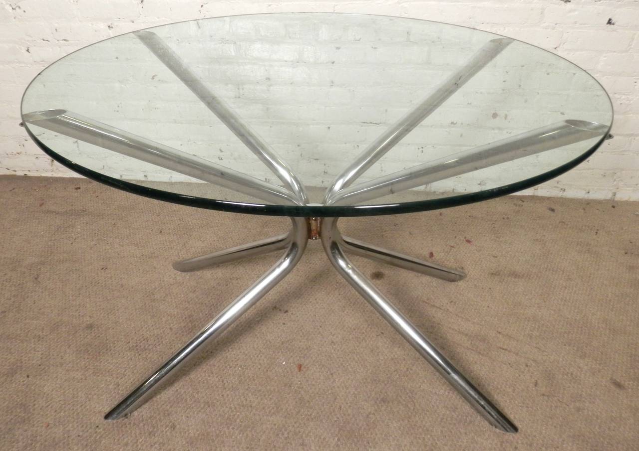 Striking and simple in style with a polished tubular chrome base under a clear round glass top. Makes a great dining tables, console table or tall pedestal table, depending on the size of glass.

(Please confirm item location - NY or NJ - with