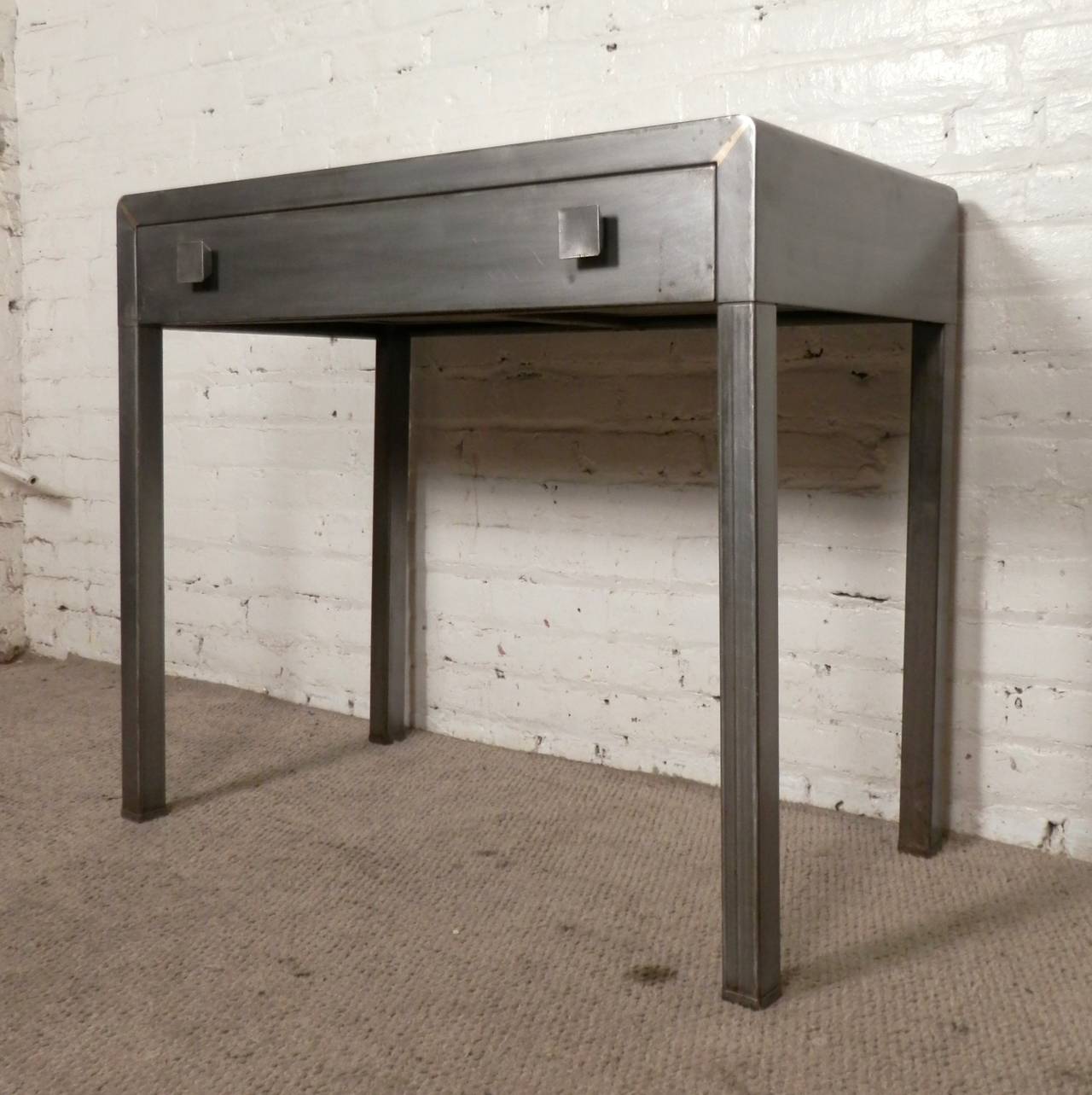 Simple and stream-lined design by Norman Bel Geddes for Simmons Furniture. All metal with large square handles. Newly refinished in a bare metal style finish.
Kneehole: 31w 19d 24h

(Please confirm item location - NY or NJ - with dealer)