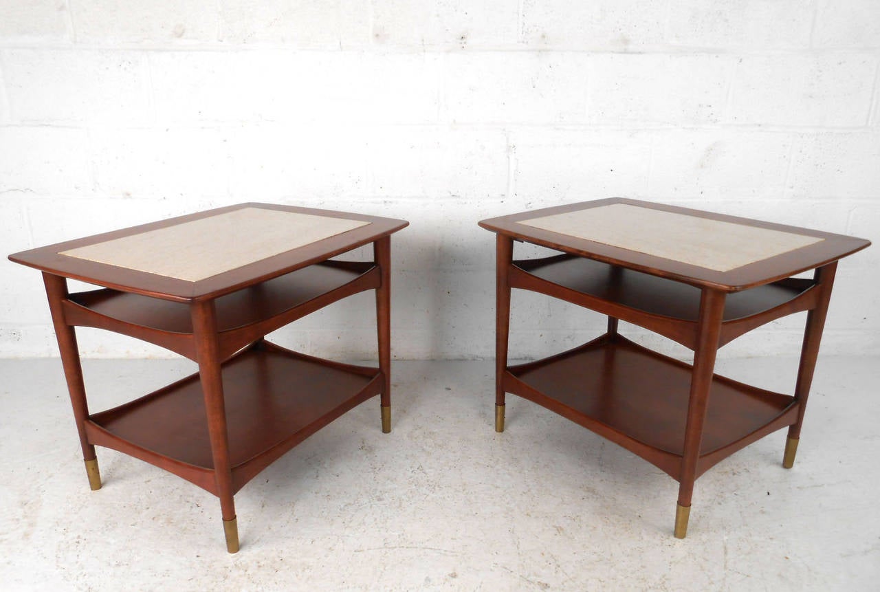 This matching midcentury pair features American walnut construction inlaid with marble tops. A wonderful three-tier design with two lower shelves that offers a convenient and stylish place to set items. Unique sculpted stretchers add stability as