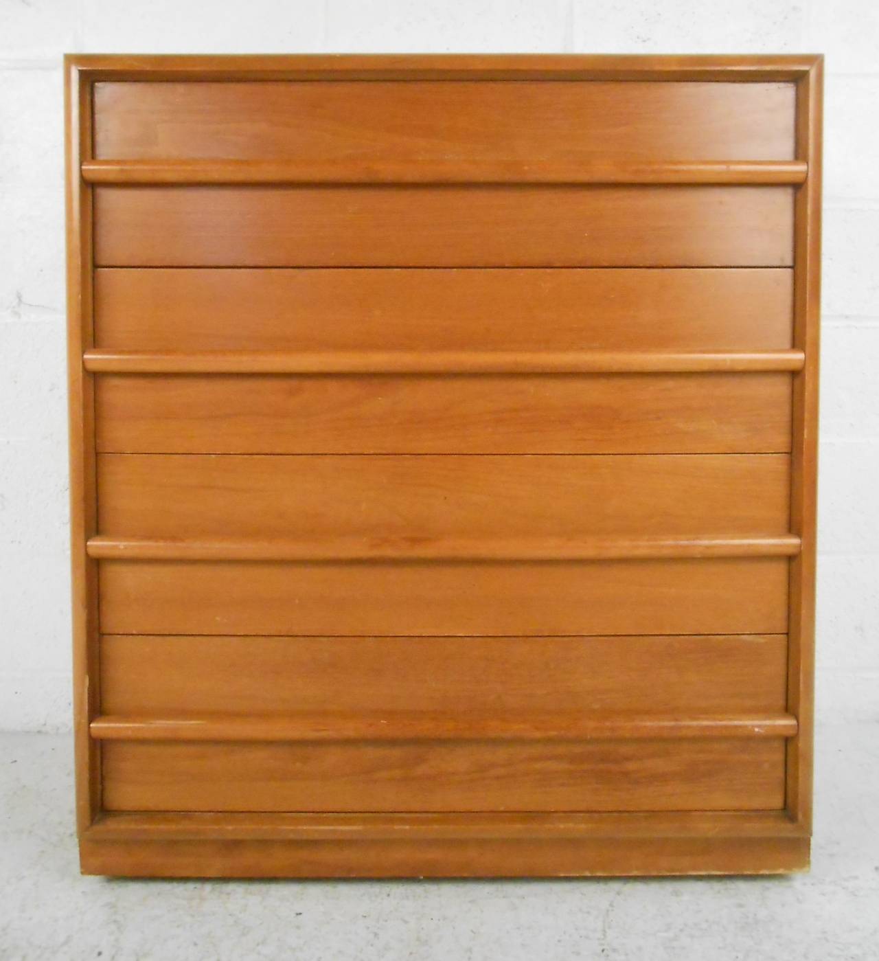 Walnut four drawer highboy designed by TH Robsjohn-Gibbings. Please confirm item location (NY or NJ) with dealer.