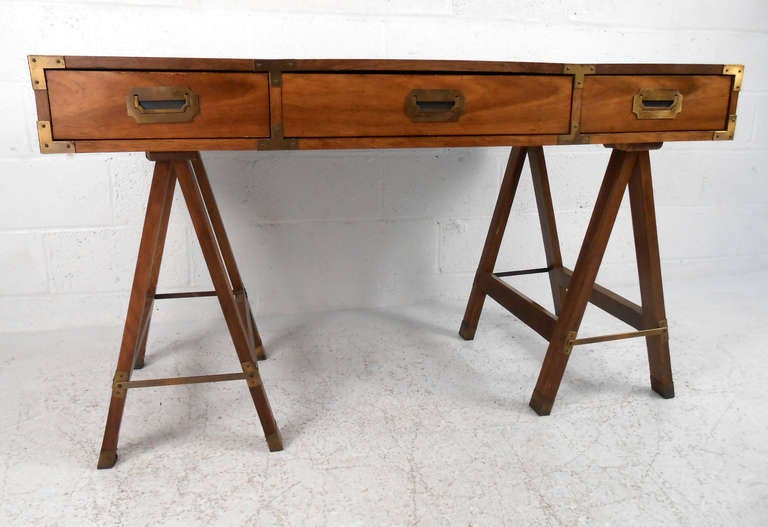 This vintage campaign desk by Bernhardt provides a unique writing desk with durable formica style top. With saw-horse style legs and plenty of storage this piece makes a wonderful addition to home or business. Please confirm item location (NY or NJ).