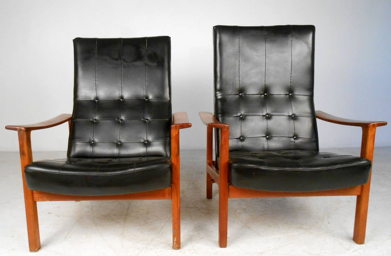 This unique pair of teak and vinyl reclining lounge chairs feature unique back adjustment, wonderful tufted design, and sturdy construction. Fantastic matching pair from Swedish Bröderna Andersson, perfect addition to any seating arrangement. Please