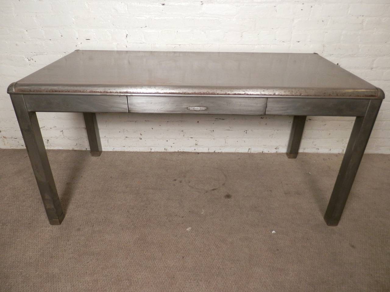 Attractive over-sized metal factory desk made by Yawman & Erbe Mfg Co. (