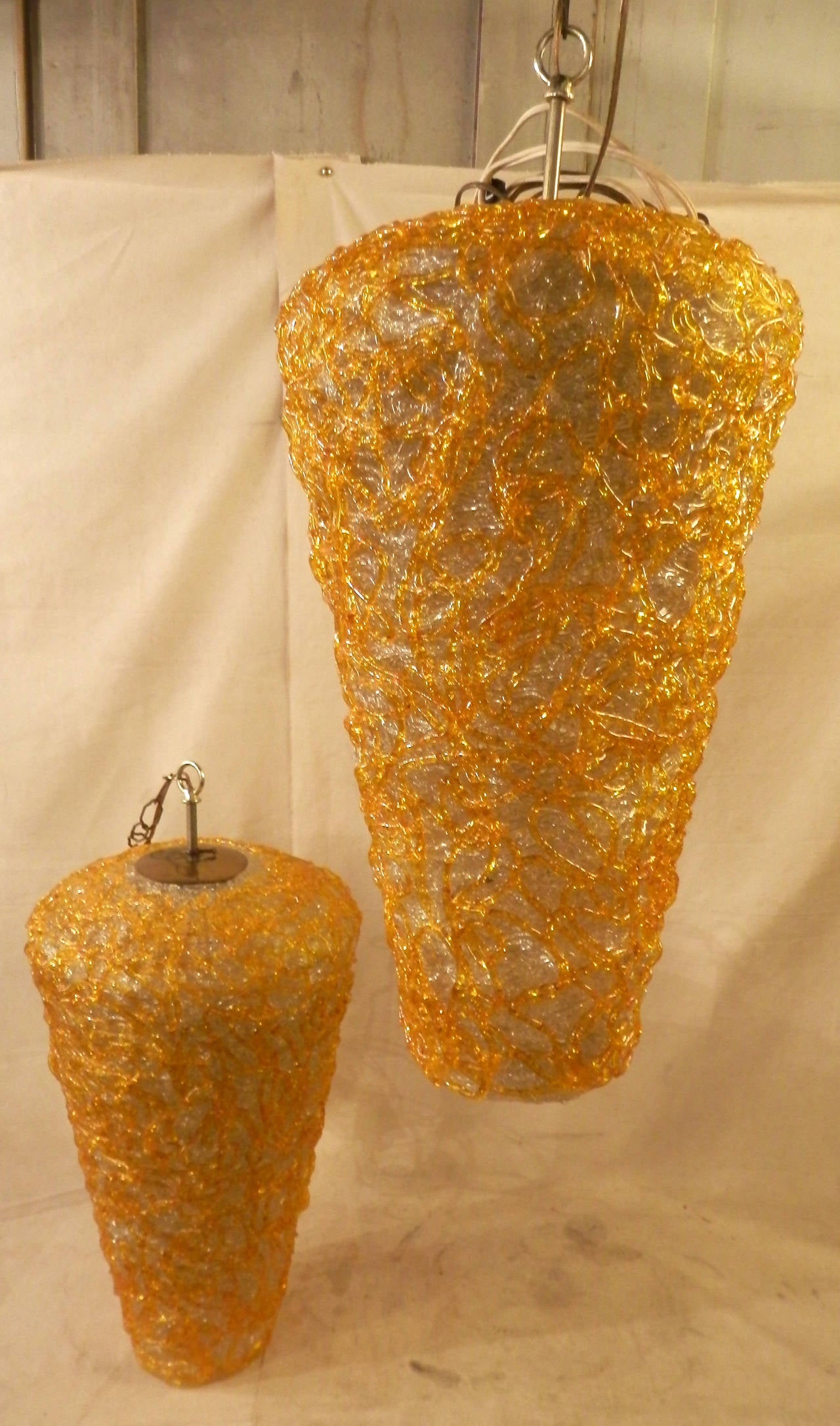 Beautiful pair of yellow and white spaghetti style spun Lucite hanging lamps.
Each has one bulb socket and a brass stem. Height can be adjusted by the chain.

(Please confirm item location - NY or NJ - with dealer)