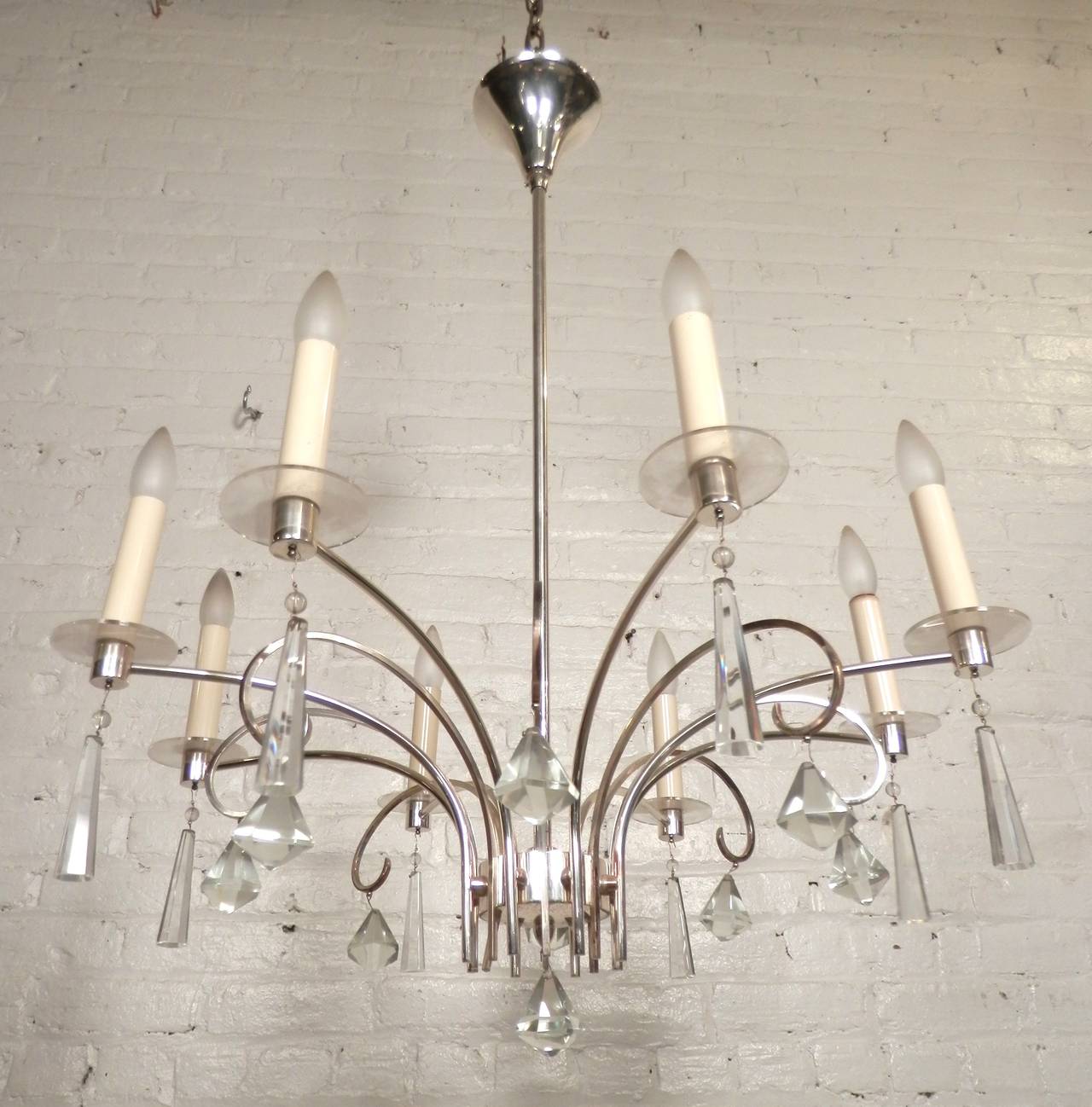 Mid-Century chandelier with cut glass crystals and elegant chrome arms. Delicate swooping lines, eight candlestick sockets.

(Please confirm item location - NY or NJ - with dealer)