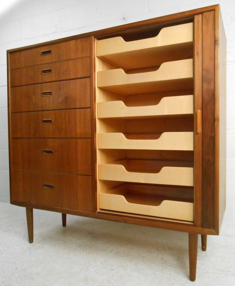 Danish teak 12 drawer dresser by quality manufacturer Falster. Recessed pulls on six drawers and tambour door conceals six additional pull-out trays.