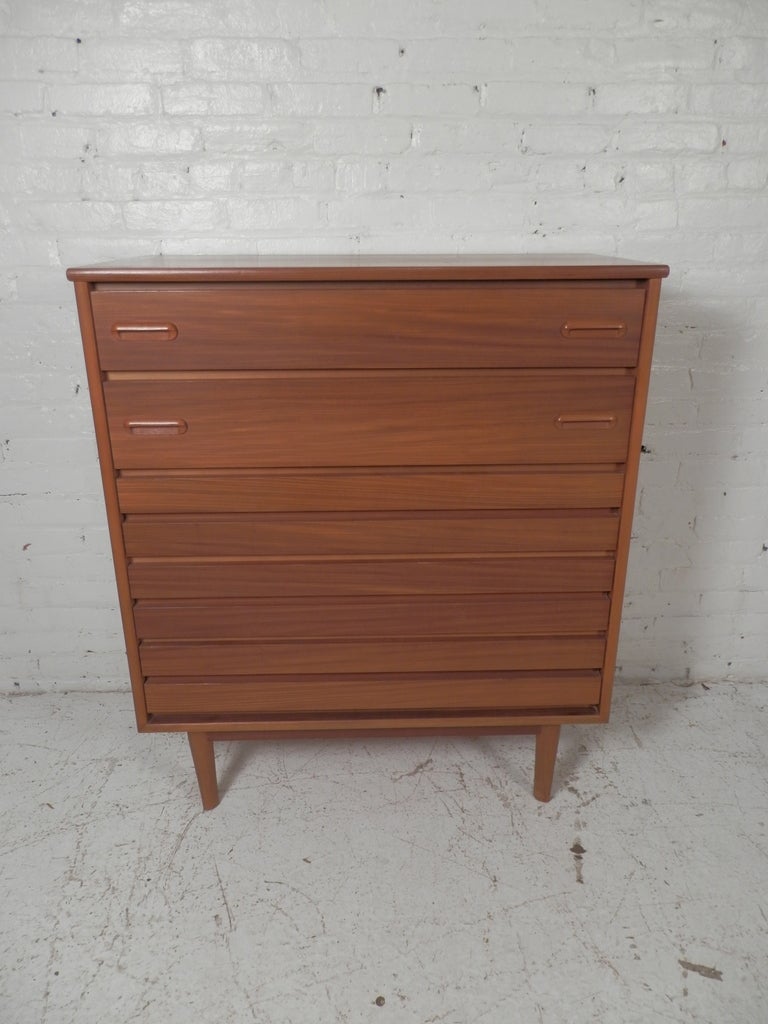 A great looking highboy dresser from quality furniture company Stanley. This dresser has a Danish modern look with it's flat front and inset drawer pulls. Very sturdy, and very handsome.

Email for location.