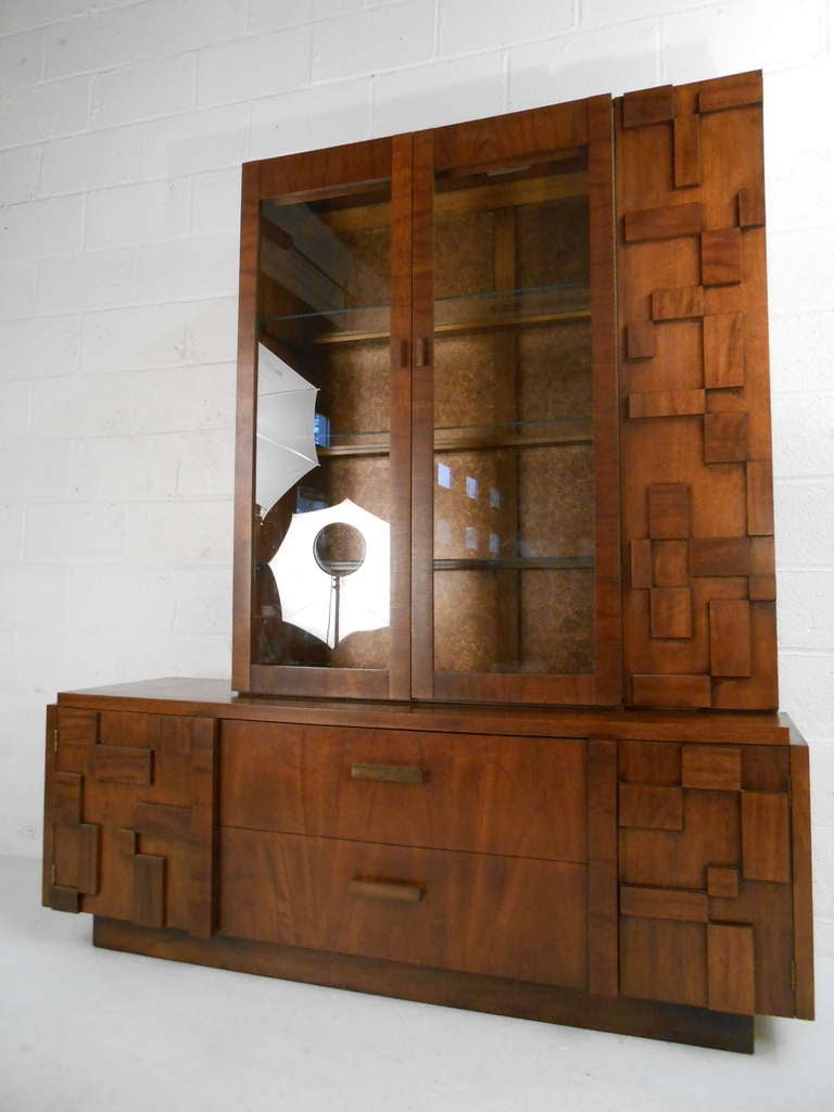 Two piece Brutalist design cabinet with server combination in the style of Paul Evans. Three glass display shelves in the upper unit and the bottom consists of two drawers and and two door storage compartments. Please confirm item location (NY or