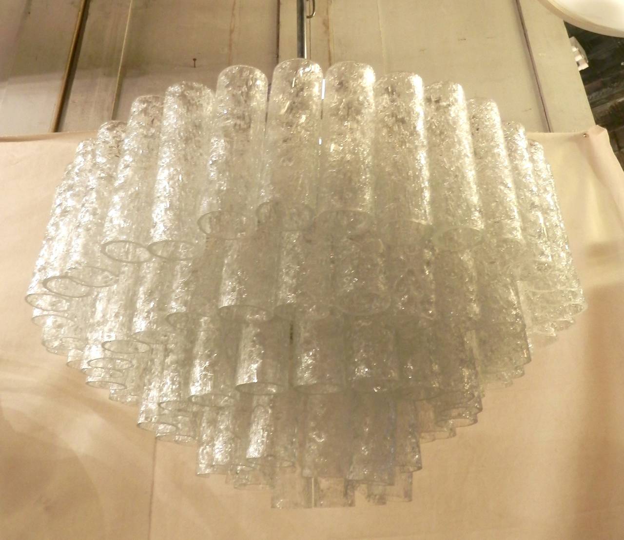 Elegant chandelier with beautiful array of cascading crackled glass pendants. Excellent lighting with sockets for up to ten bulbs. Long chrome stem and frame with semi-clear glass suspended.

(Please confirm item location - NY or NJ - with dealer)