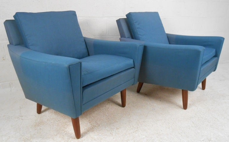 Pair of sturdy, well constructed Danish upholstered club chairs with tapered rosewood legs. (Please confirm item location - NY or NJ - with dealer).