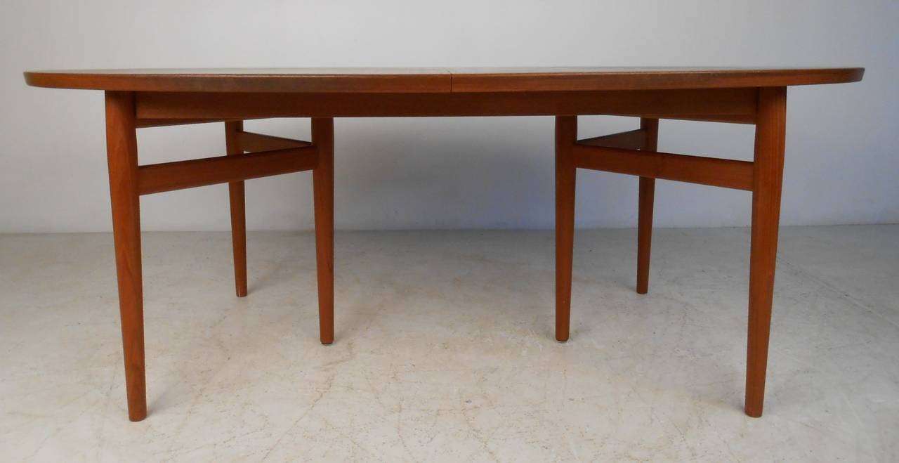 Teak Danish modern six-leg table and eight matching chairs by Arne Vodder for Sibast. Measure: Oval table expands from 78