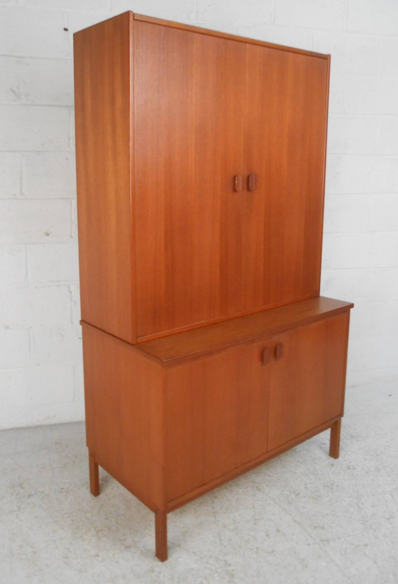 This beautiful storage cabinet features sturdy mid-century construction, fantastic teak finish, and makes a unique storage solution for any room. Two separate pieces increase the versatility of this Swedish cabinet. Perfect for office, living room,