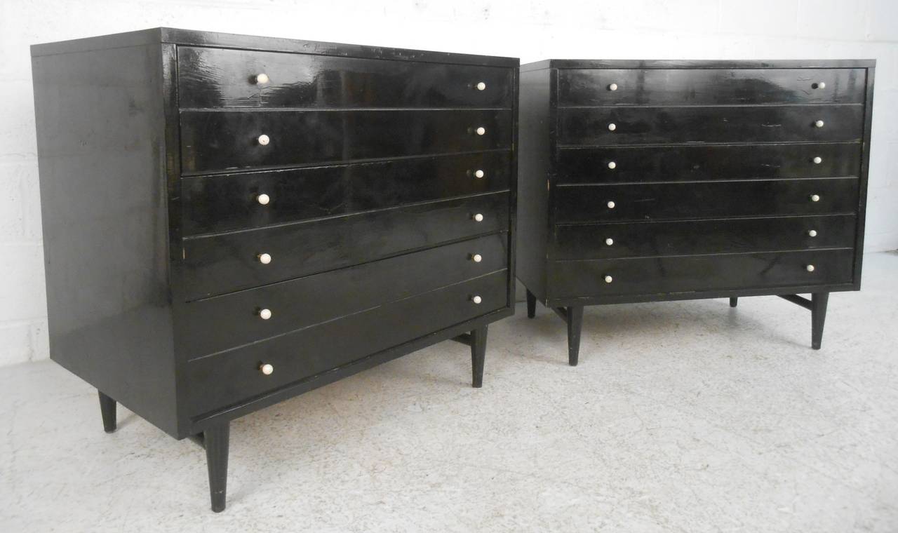 Pair of American of Martinsville glossy black dressers with white laminate tops and white pulls.  Each dresser contains three 7