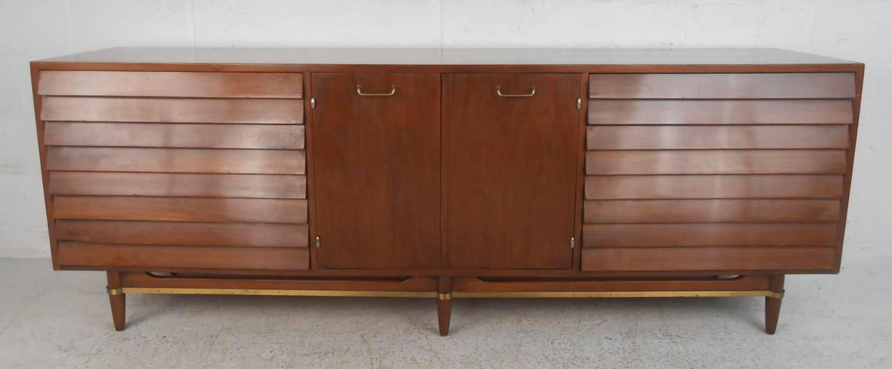 Beautifully detailed long walnut louvered credenza designed by Merton L. Gershun. Please confirm item location (NY or NJ) with dealer.