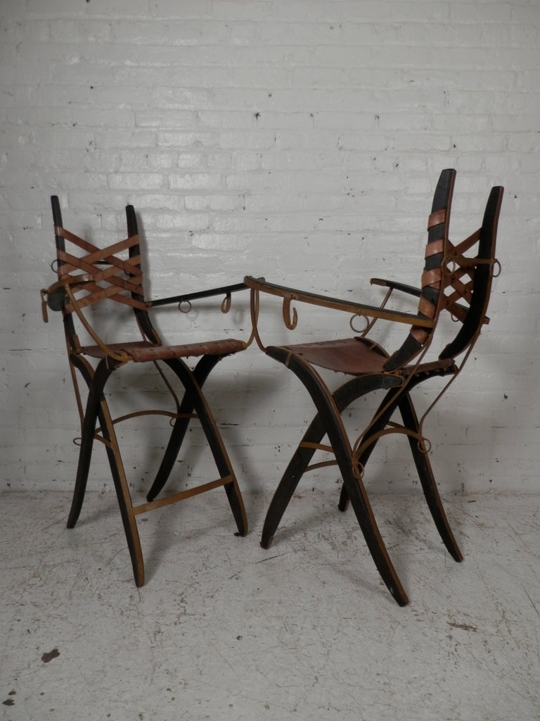 Unique tall chairs with leather seat and strapping on back. Signed by the designer on the back. Very different style.

(Please confirm item location - NY or NJ - with dealer).