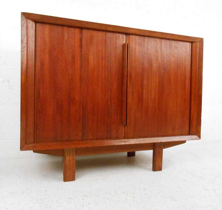 Tambour door record cabinet in teak. Please confirm item location (NY or NJ) with dealer.