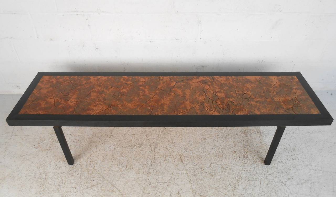 This unique copper top coffee table adds a unique flare to a classic midcentury coffee table design. Wonderful textured metal table top and sturdy construction make this the perfect centre table for any seating area. Please confirm item location (NY