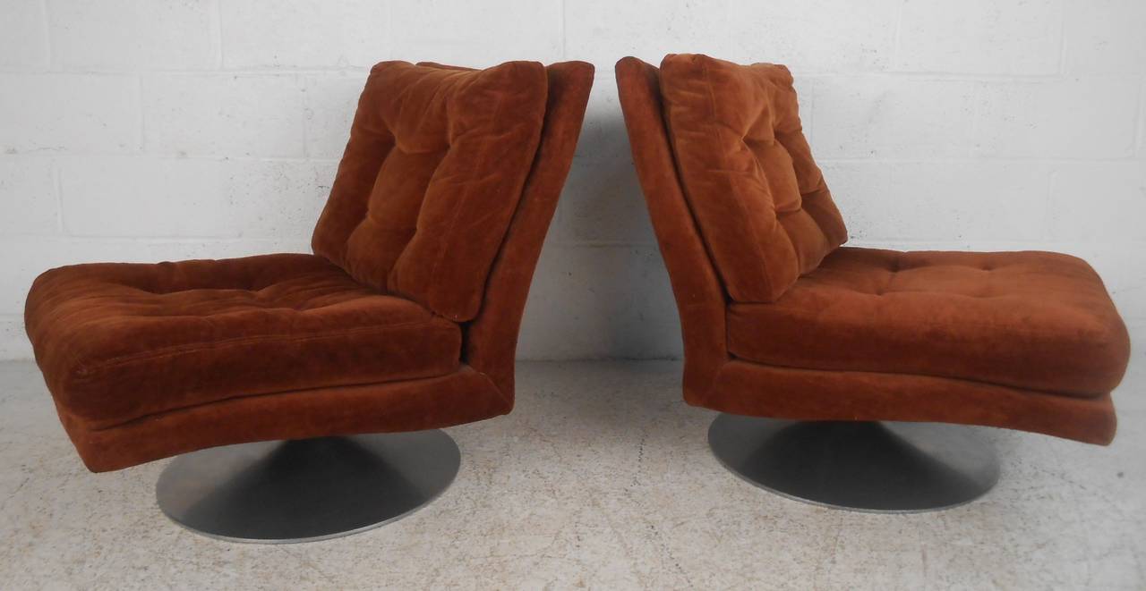 Pair of swivel lounge chairs attributed to Milo Baughman and manufactured by Thayer Coggin (label). Stylish slipper design with tufted vintage upholstery make a memorable addition to any interior. Please confirm item location (NY or NJ) with dealer.