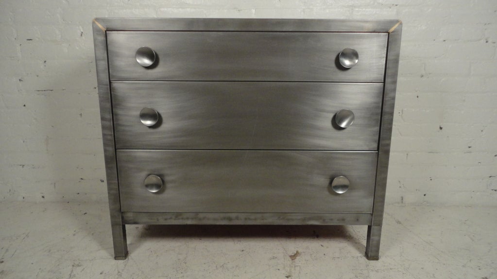 Three drawer bare metal dresser by Simmons Furniture Company.
