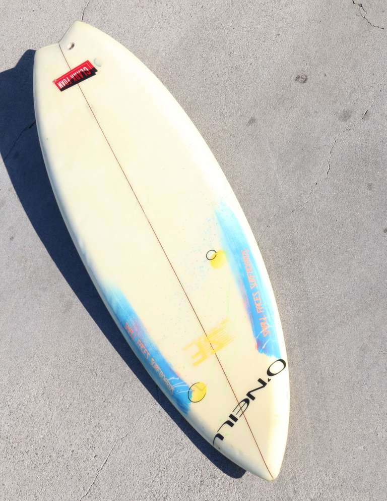 This board was shaped for Buttons in the late 1970s or early 1980s.  This is a team rider surfboard.  The Clark Foam and O'Neill logo decals are under the fiberglass and were applied before the fiberglass was added.  These decals denote sponsorship