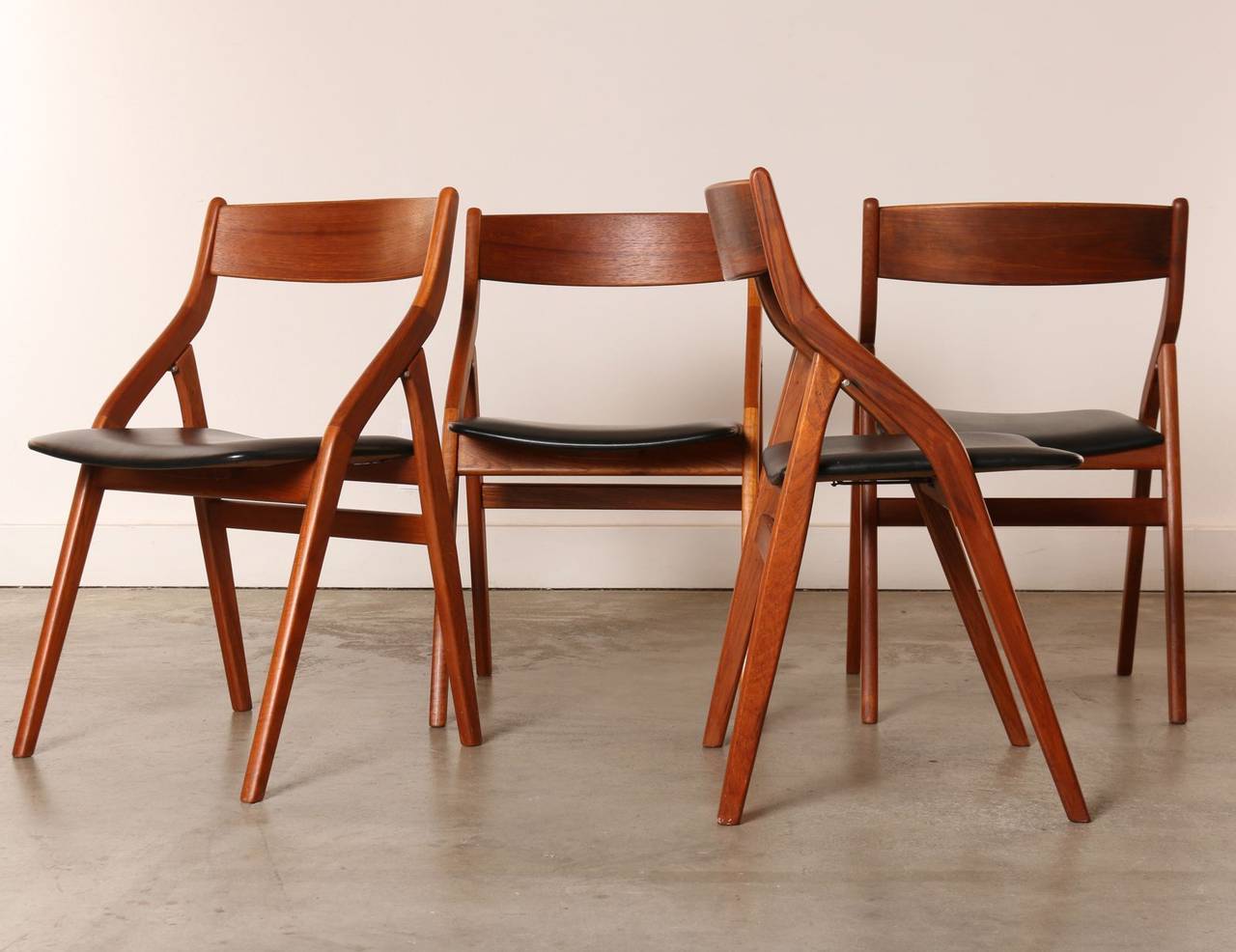 It's rare to find a set of solidly built Danish modern folding chairs that are stylish and elegant as well as comfortable. 

These chairs have a beautiful profile featuring gentle curves accented by clean angular Mid-Century lines. 

When folded