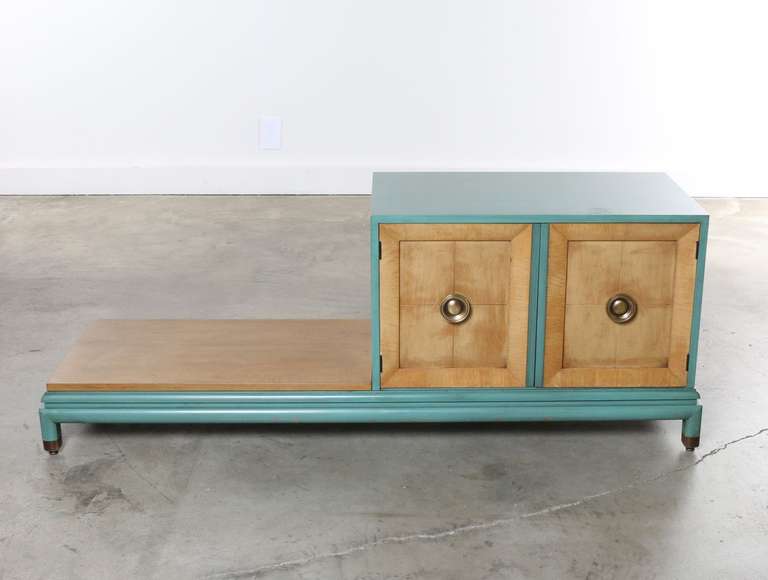 Unique combination cabinet and low bench table by Renzo Rutili for the Johnson Furniture Company. This unit features an original aqua lacquer enamel paint finish on areas of the exterior and the cabinet interior that contrasts nicely with the wood
