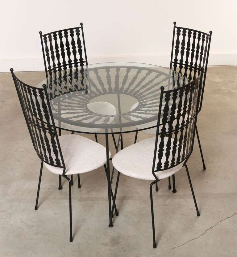 This round wrought iron table and four matching (and comfortable) high back chairs are perfect for the patio or garden. This set features quality hand hammered wrought iron craftsmanship finished with gilt ball finials on the corners of the high