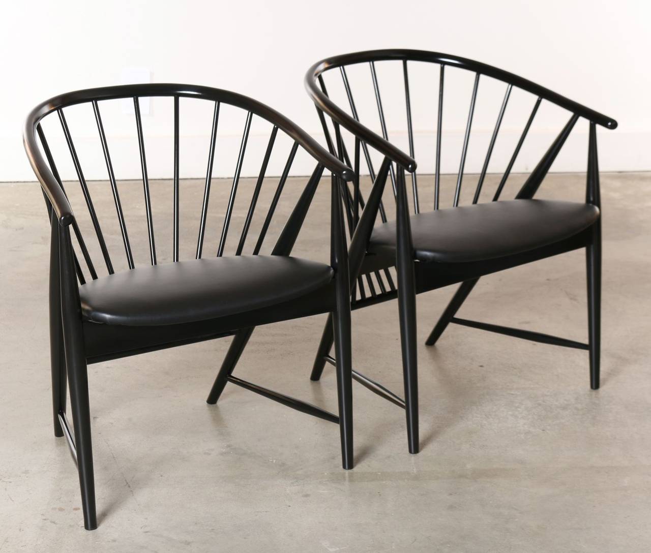 Created by Swedish designer Sonna Rosen for Nassjo Stolfabrik in 1948. This chair received its name from the solid beechwood spindles and shapely frames that fan into an elegant sun feather design. A work of art viewable from every angle. This pair