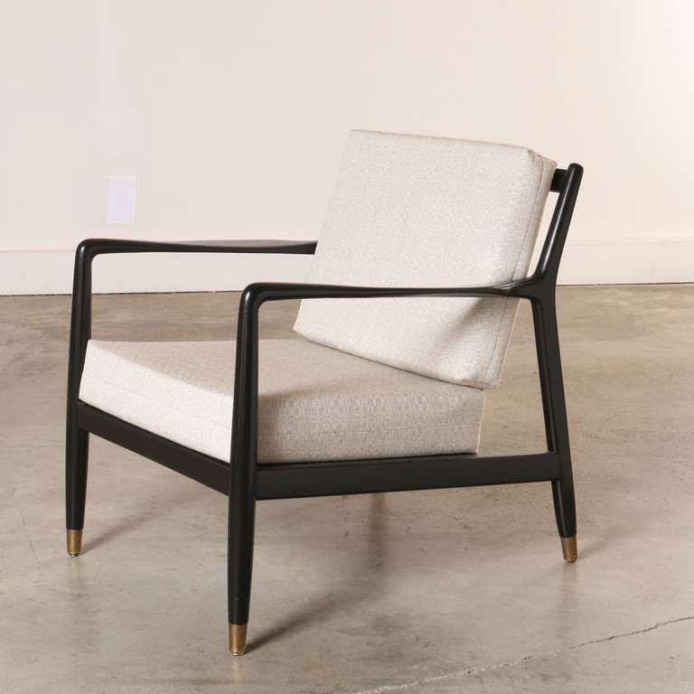 Made by Dux, this newly refinished black wooden chair is one of the more desirable designs of an era. Often emulated but rarely matched in quality or styling. This chair is classic, comfortable and extremely well made.  It sports an open frame with