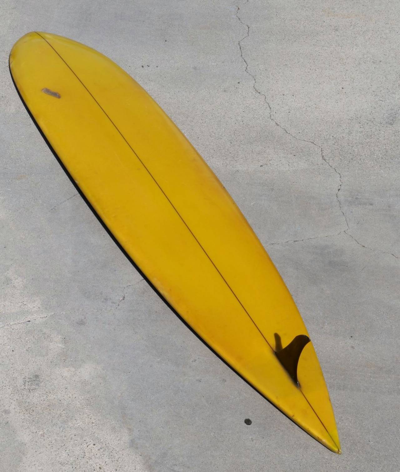Beautiful Hawaiian big wave gun handcrafted the 'Old School' backyard way. This stellar board has style, panache and just a little swagger. Vibrant yellow rails with black pinstripe surround a paisley design of green, blue and dark red. The yellow