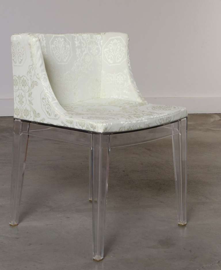 Pair of Mademoiselle Chairs designed by Philippe Starck and manufactured by Kartell in Italy.
The Chair frames are made of transparent shatter and scratch resistant polycarbonate material with a white and cream damask upholstered seat.

Philippe