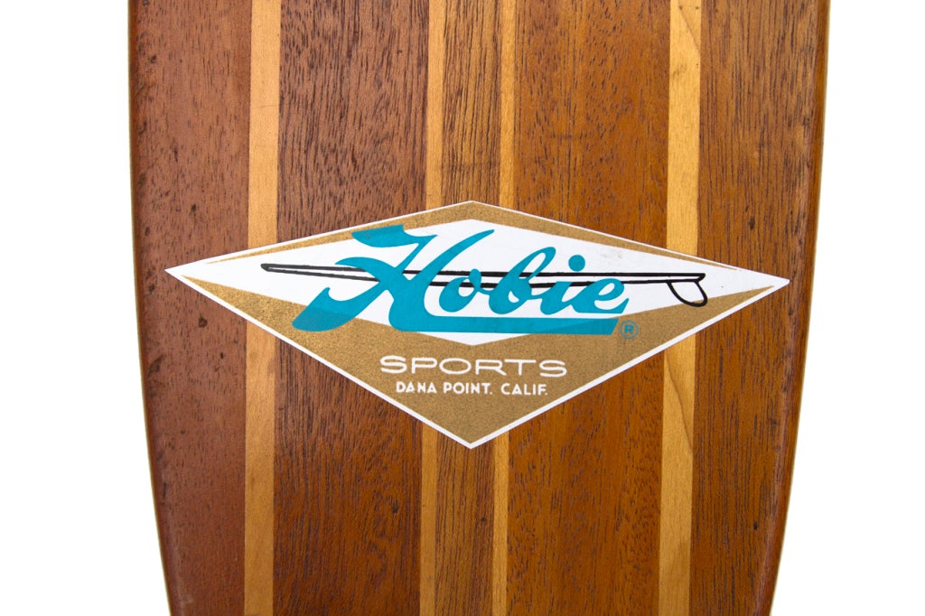 The Hobie Surfboard Company got into the skateboards craze early.  This board has been fully refurbished with a non-original decal.  Clay wheels and trucks are original.  A beautiful display board.
