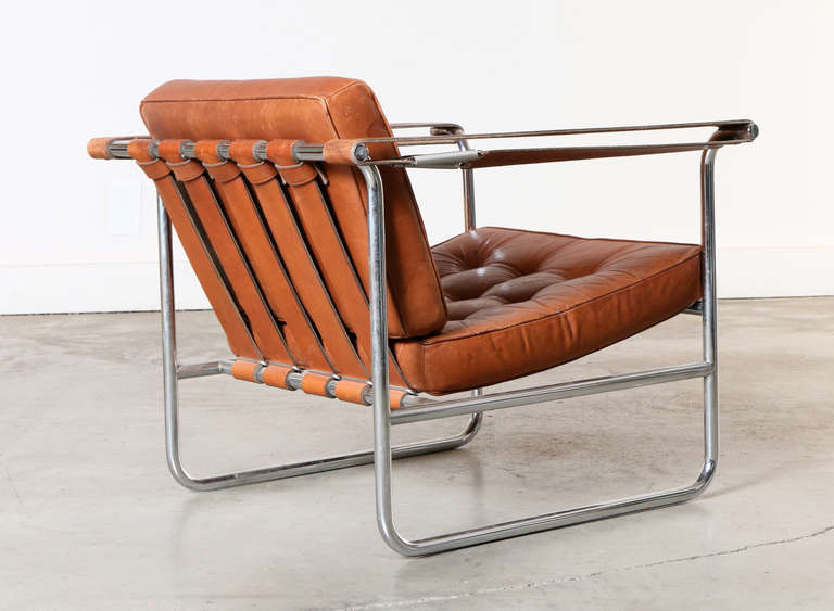 Pair of leather and chrome lounge chairs designed by Swiss architect Karl Thut and made by Stendig in Switzerland in the 1970's.
Chrome tubular frame with adjustable leather straps featuring a unique spring tension arm strap. The chairs are