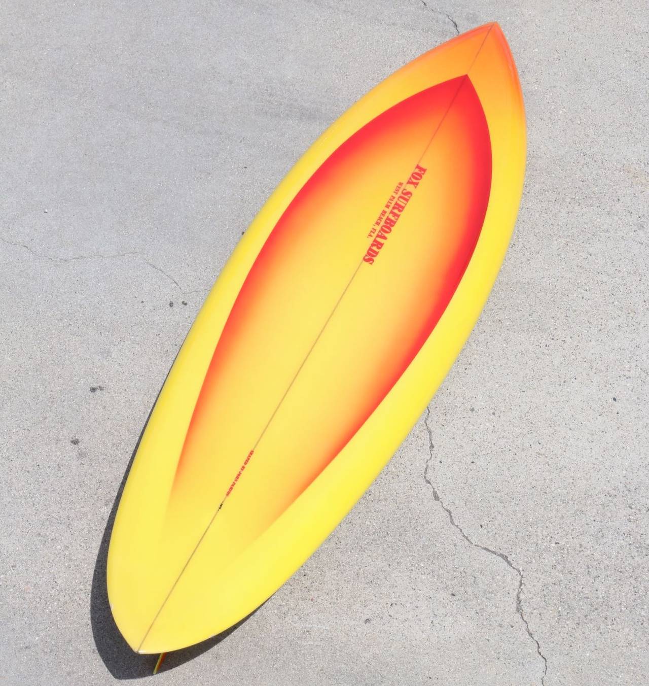 Vibrant orange fades to bright sun-kissed yellow on this energetic 1970s fox surfboard, masterfully shaped in the 