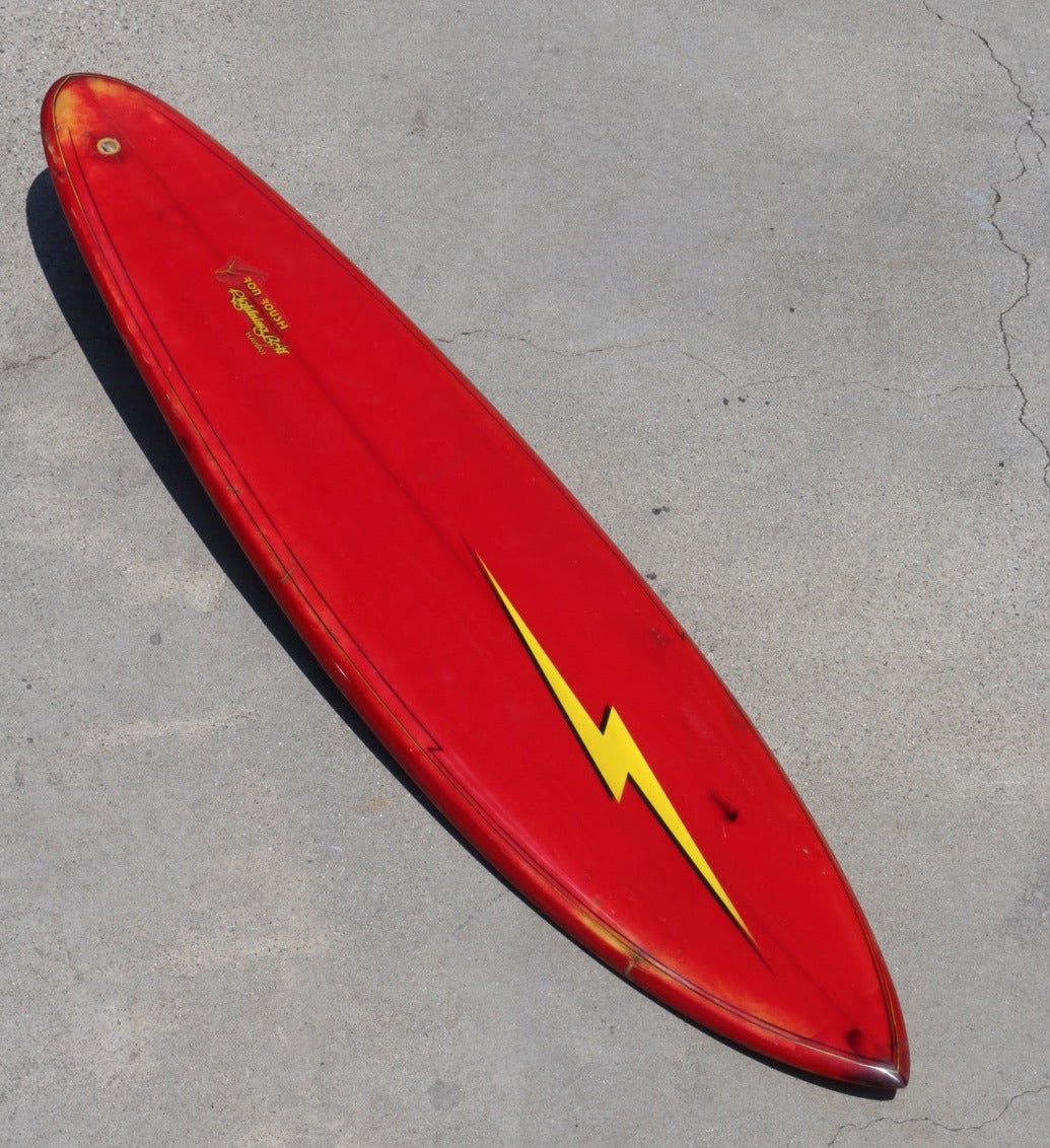 This much loved and well used mid-1970s Lightning Bolt Surfboard was shaped in Hawaii by master maverick shaper Ron Roush. Signed 