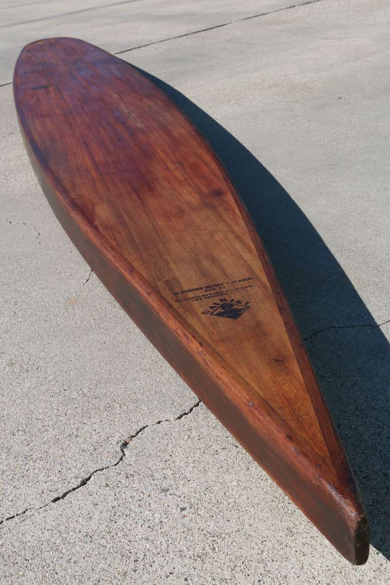 A 1930s Pacific Homes Waikiki wooden paddleboard is ultra rare, especially when it's in good, all original, condition. As these boards were made of wood and often shared by family members or friends they became waterlogged or sun-beaten over time.