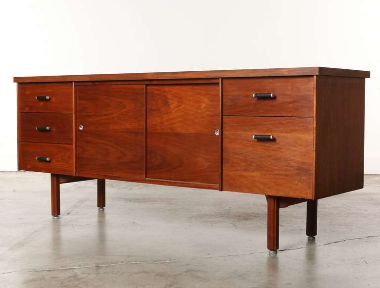 Sturdy Walnut credenza with aluminum and leather handles, four drawers, one file drawer and a center storage compartment with two shelves. Sits on elegant walnut legs. Back is finished.<br />
<br />
The Dictaphone company acquired Vista-Costa Mesa