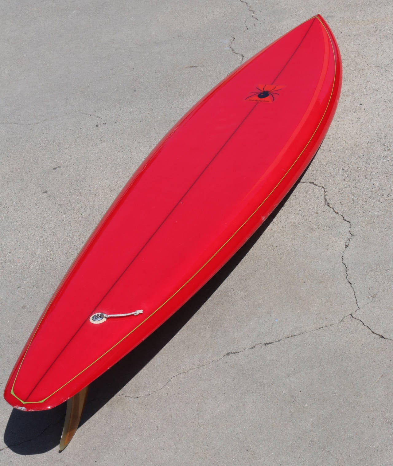 Color and verve is rolled into one in this vintage board by Santa Cruz Surfboards. The shape, the form, the color and the energy make this a great example of an early 1970s board.

Cherry red, lime green pin striping, black spider logo and a shape