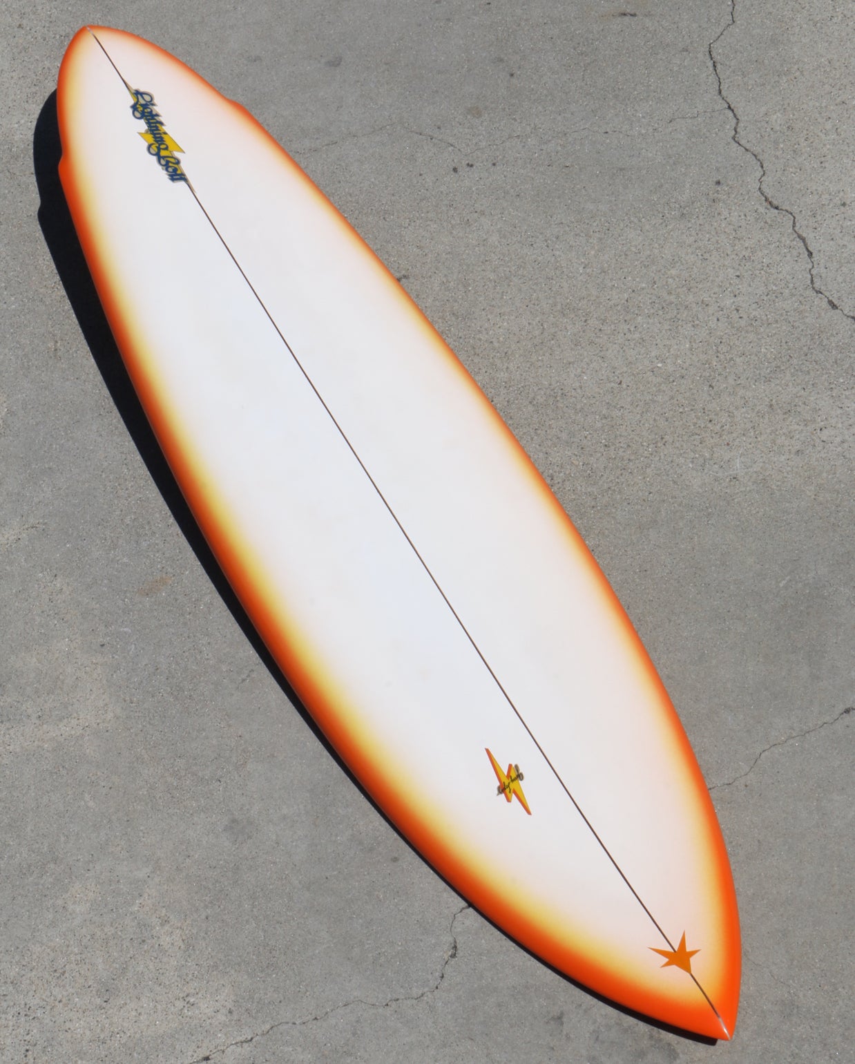 This is a rare 1976 Lightning Bolt Surfboard made by legendary shaper Terry Martin. Fully restored and measuring in at 6’9” this beautifully rounded swallow pintail board is a real eye-catcher. The bottom is as is exciting as the deck with color and