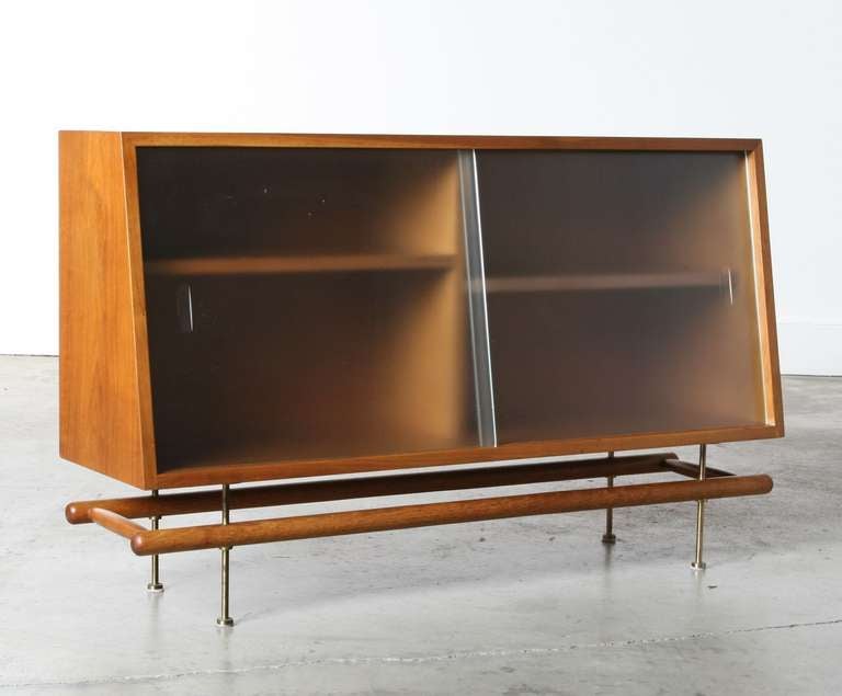 This Greta Magnusson-Grossman display cabinet for Glenn of California offers a graceful storage solution. Place on top of a buffet, sideboard or credenza and enjoy clean Mid-Century lines, glorious wood tone, sturdy shelves, glass sliding doors and