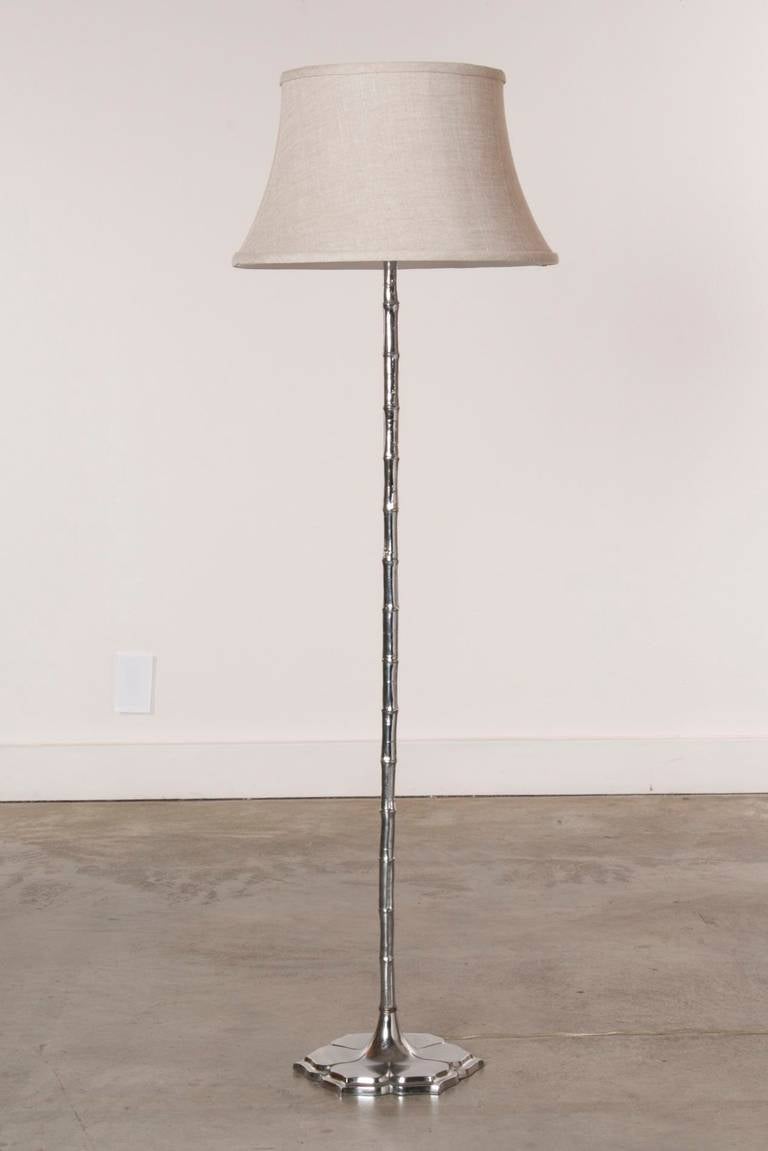 Mid-Century Modern merges with Pacific Island and Plantation aesthetics in this Asian influenced, chromed faux bamboo floor lamp.  The striking lamp stem features a beautiful lotus flower design base that offers both stability and style.

This