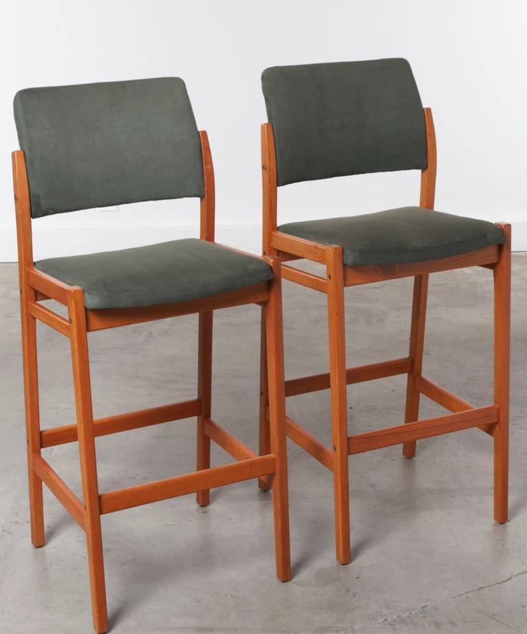 Bar height stools with teak frames and upholstered seats.  Comfortable and supportive with contoured high backs, firm seats, solid teak tapered legs and foot rest.
Stamped on the underside of the seat Made in Sweden by Svegards Markaryd 
circa