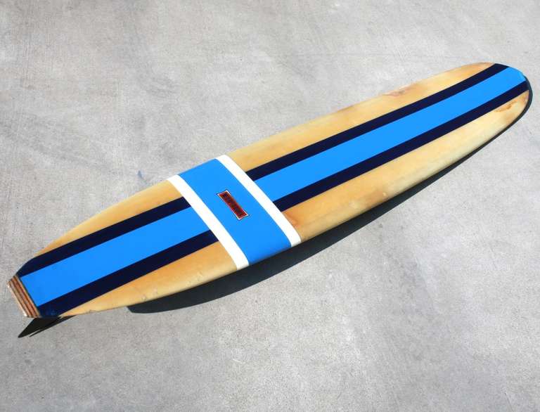 Towering in at 10 feet high this Weber Performer Surfboard was produced by the world famous Dewey Weber and shaped in Venice California circa 1966.

Featuring great big blue vertical and horizontal stripes and a red wood tail-block and 12