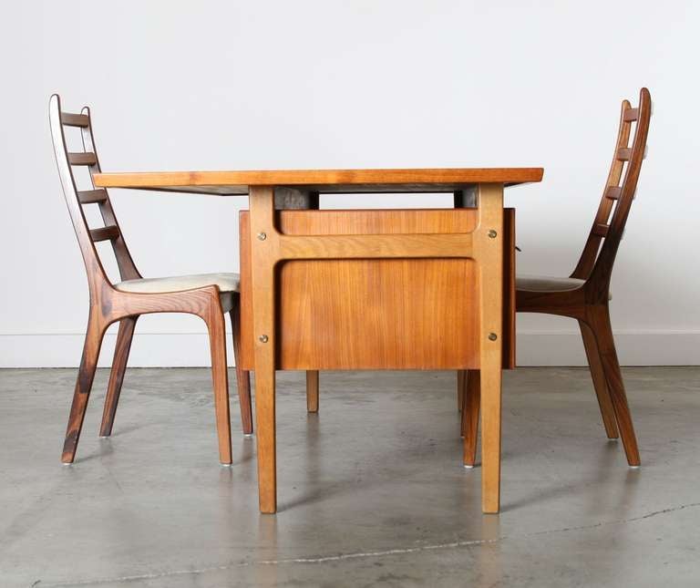 Great lines and work area for two.  Designed by Torben Strandgaard in the 1960's this teak and cane partners desk is well constructed for years of use and features sculptural brass drawer pulls and a woven cane front for sustaining beauty.
