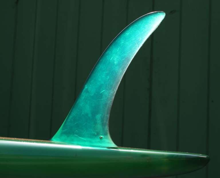 This is a rare Greg Noll signature surfboard the Fain's Formula 2 Model.  It is a transitional board measuring 8 feet long and was in production in Hermosa Beach, California between 1965/1969.  

Cream with green trim and graphics of the late 60's